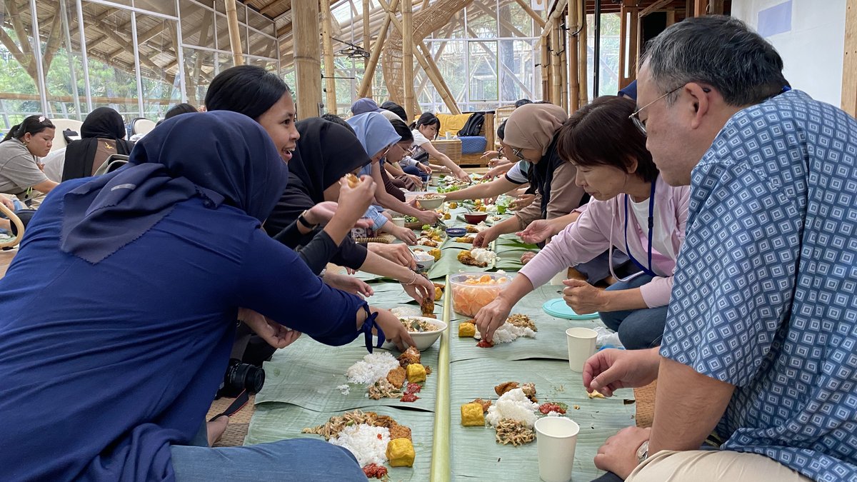 Guests sharing a Sundanese feast on banana leaves